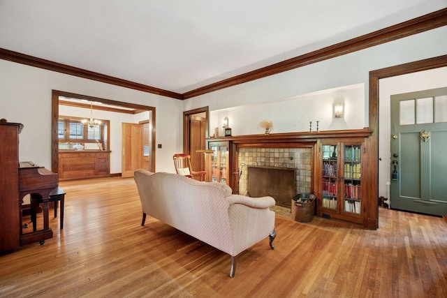 73 Arthur Ave SE, Minneapolis, MN 55414 - living area featuring a chandelier, wood-type flooring, a fireplace, and ornamental molding