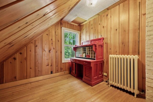 73 Arthur Ave SE, Minneapolis, MN 55414 - additional living space featuring radiator heating unit, light wood-style floors, vaulted ceiling, and wooden walls