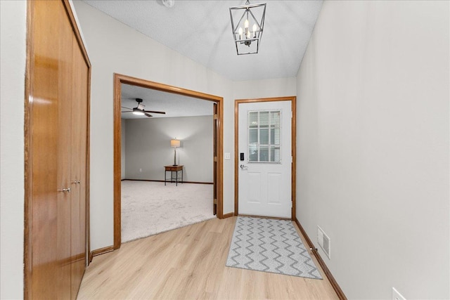 7514 Ojibway Park Rd, Woodbury, MN 55125 - doorway with light wood-style flooring and a chandelier