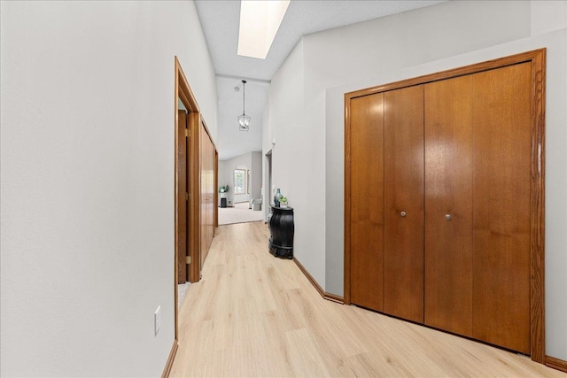 7514 Ojibway Park Rd, Woodbury, MN 55125 - corridor with light wood-style floors and a skylight