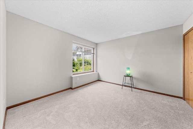7514 Ojibway Park Rd, Woodbury, MN 55125 - carpeted empty room with a textured ceiling and baseboards