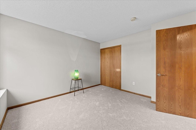 7514 Ojibway Park Rd, Woodbury, MN 55125 - unfurnished bedroom with carpet floors, a closet, and a textured ceiling