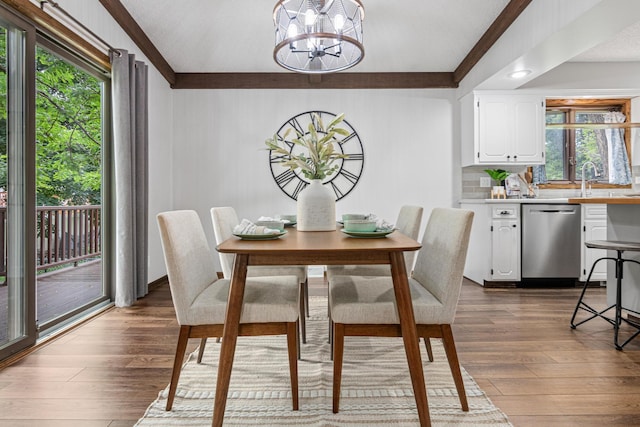 7401 River Shore Ln, Champlin, MN 55316 - dining room featuring a chandelier, dark wood-style floors, and crown molding