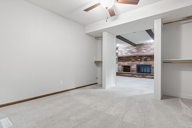 7401 River Shore Ln, Champlin, MN 55316 - unfurnished living room with carpet flooring, a brick fireplace, ceiling fan, and a textured ceiling