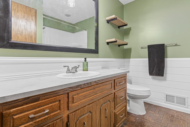 7401 River Shore Ln, Champlin, MN 55316 - bathroom with vanity, wainscoting, a shower, and brick patterned flooring