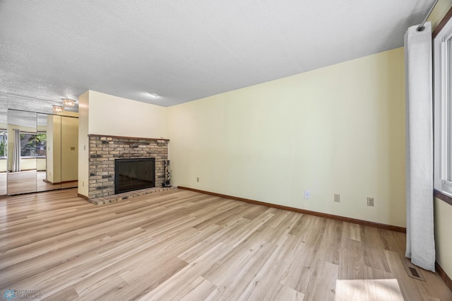 3237 17th Ave S Unit 101, Fargo, ND 58103 - unfurnished living room with light wood finished floors and a brick fireplace