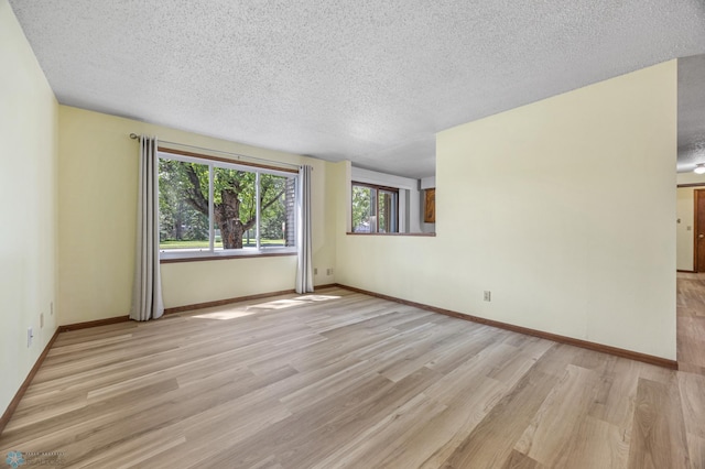 3237 17th Ave S Unit 101, Fargo, ND 58103 - spare room featuring a textured ceiling and light wood finished floors