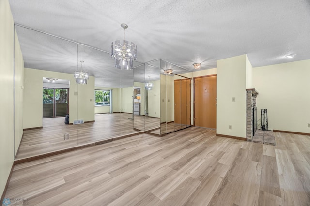 3237 17th Ave S Unit 101, Fargo, ND 58103 - unfurnished room featuring a chandelier, wood finished floors, and a textured ceiling