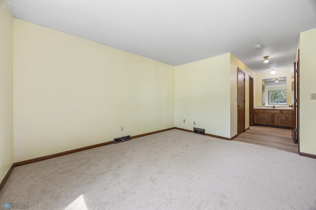 3237 17th Ave S Unit 101, Fargo, ND 58103 - spare room featuring light carpet and baseboards