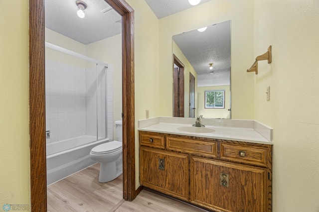 3237 17th Ave S Unit 101, Fargo, ND 58103 - bathroom with a textured ceiling, wood finished floors, vanity, and bathtub / shower combination