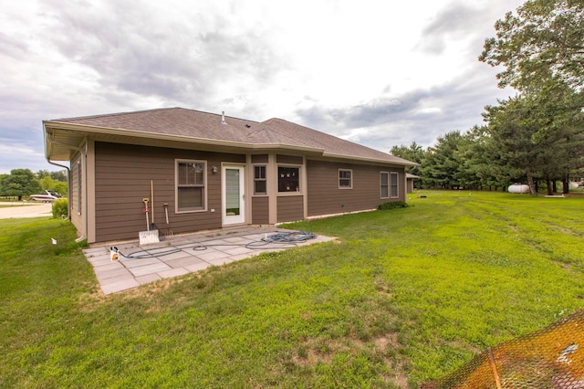 15212 667th St, Wabasha, MN 55981 - back of house featuring a yard, a patio, and a shingled roof