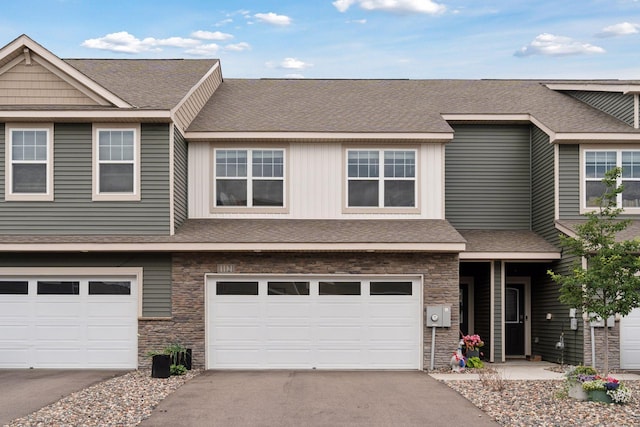 11121 Balsam Pointe Trl, Dayton, MN 55327 - view of front of property with stone siding, an attached garage, asphalt driveway, and a shingled roof
