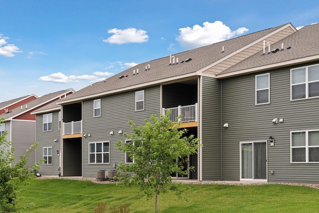 11121 Balsam Pointe Trl, Dayton, MN 55327 - rear view of house featuring a balcony, a yard, and a shingled roof