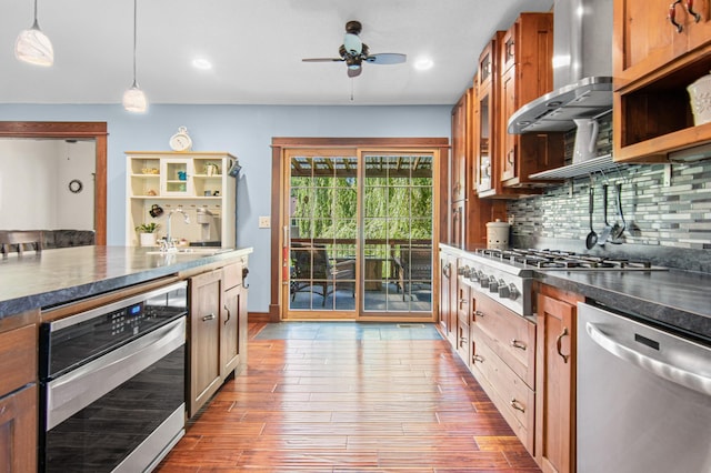 1962 72 1/2 St, Centerville, MN 55038 - kitchen with appliances with stainless steel finishes, wall chimney exhaust hood, ceiling fan, dark countertops, and decorative backsplash