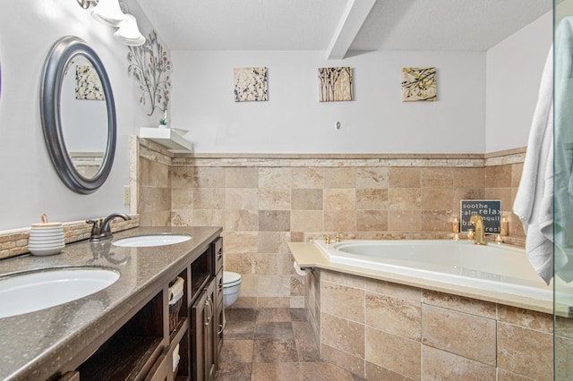 1962 72 1/2 St, Centerville, MN 55038 - full bathroom featuring double vanity, a bath, stone finish floors, and wainscoting