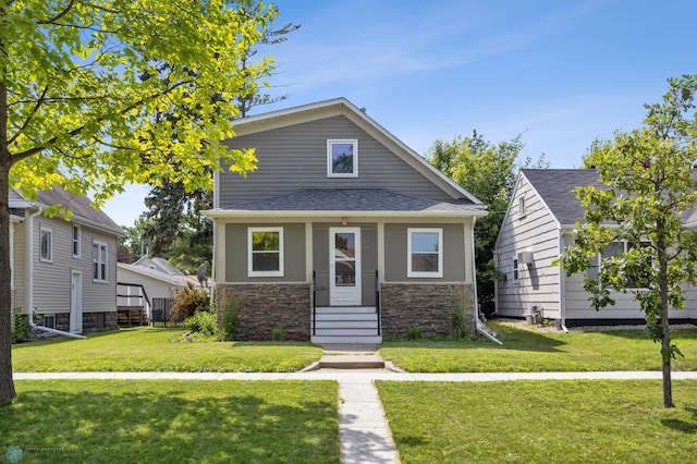726 Oak St N, Fargo, ND 58102 - view of front of home with stone siding, a front yard, entry steps, and a shingled roof