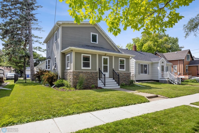 726 Oak St N, Fargo, ND 58102 - view of front of home with stone siding and a chimney