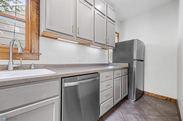 726 Oak St N, Fargo, ND 58102 - kitchen featuring stainless steel appliances, healthy amount of natural light, tile patterned flooring, and light countertops