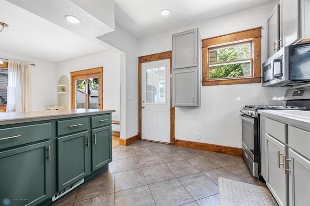 726 Oak St N, Fargo, ND 58102 - kitchen featuring green cabinetry, appliances with stainless steel finishes, healthy amount of natural light, light countertops, and recessed lighting