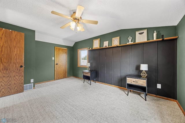 726 Oak St N, Fargo, ND 58102 - bedroom featuring carpet flooring, vaulted ceiling, a textured ceiling, and a ceiling fan