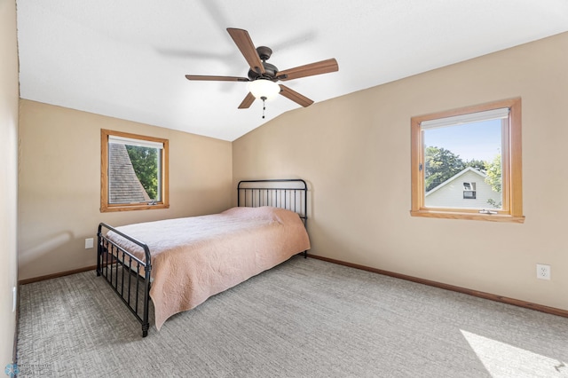 726 Oak St N, Fargo, ND 58102 - bedroom with multiple windows, light colored carpet, vaulted ceiling, and a ceiling fan