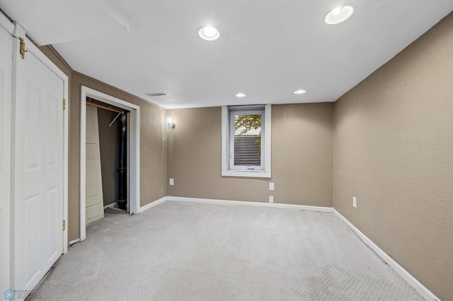 726 Oak St N, Fargo, ND 58102 - unfurnished bedroom with light colored carpet, a textured wall, and recessed lighting