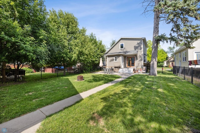 726 Oak St N, Fargo, ND 58102 - back of property featuring a gambrel roof, a fenced backyard, and a patio