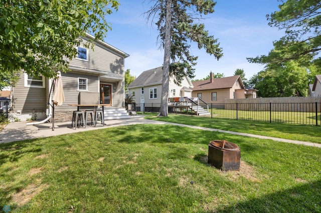 726 Oak St N, Fargo, ND 58102 - fenced backyard with an outdoor fire pit and a patio