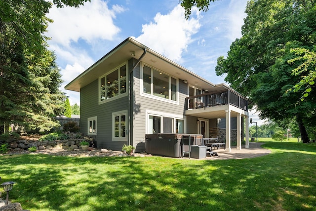 4832 Longford Rd, Mound, MN 55364 - back of house with a hot tub, a patio area, a lawn, and a balcony