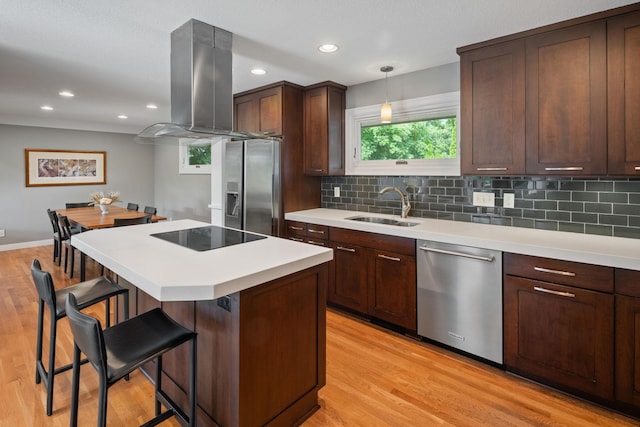 4832 Longford Rd, Mound, MN 55364 - kitchen with appliances with stainless steel finishes, island exhaust hood, a breakfast bar, light countertops, and light wood-style flooring