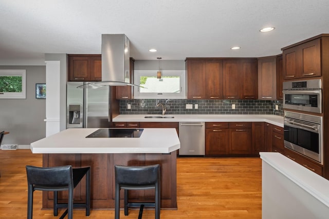 4832 Longford Rd, Mound, MN 55364 - kitchen featuring appliances with stainless steel finishes, wall chimney range hood, decorative backsplash, light wood-type flooring, and recessed lighting