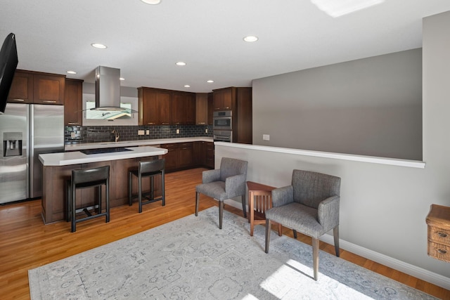 4832 Longford Rd, Mound, MN 55364 - kitchen with wall chimney range hood, stainless steel refrigerator with ice dispenser, light countertops, tasteful backsplash, and light wood-type flooring