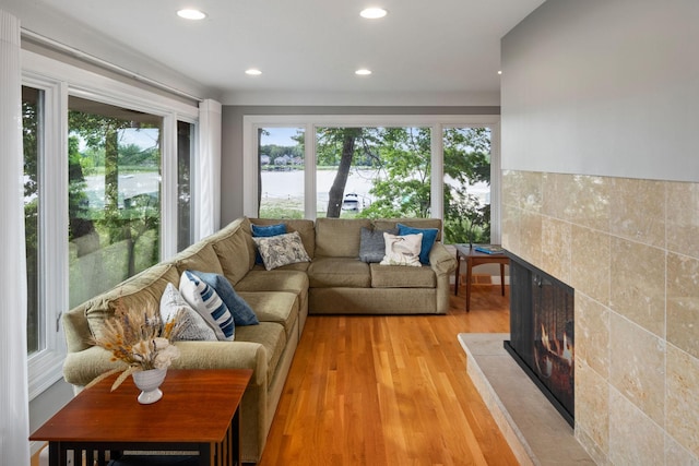 4832 Longford Rd, Mound, MN 55364 - living room featuring a tile fireplace, plenty of natural light, a water view, light wood-style floors, and recessed lighting