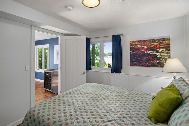 4832 Longford Rd, Mound, MN 55364 - bedroom featuring multiple windows, a textured ceiling, and wood finished floors