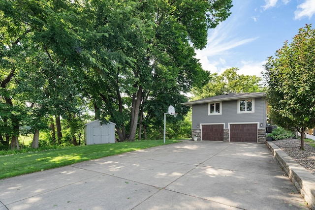 4832 Longford Rd, Mound, MN 55364 - view of property exterior featuring a storage shed, stone siding, a lawn, concrete driveway, and an attached garage