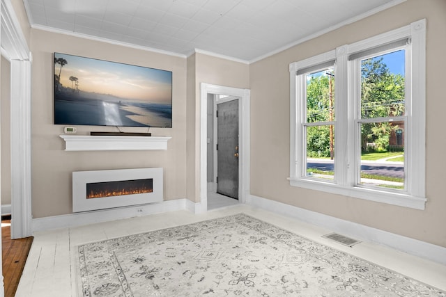 823 Owens St N, Stillwater, MN 55082 - unfurnished living room featuring crown molding and a warm lit fireplace
