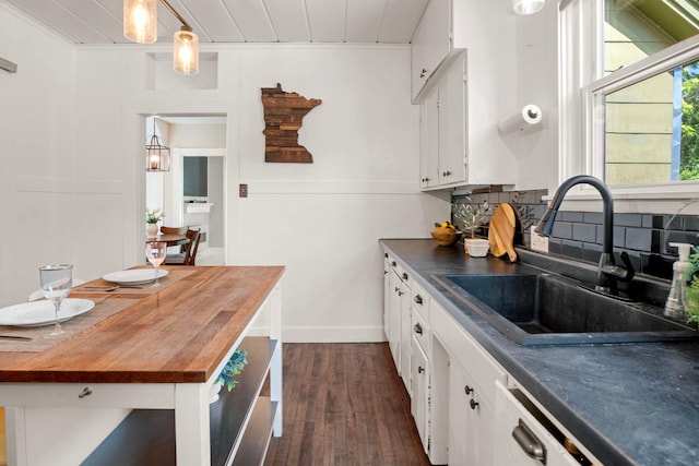 823 Owens St N, Stillwater, MN 55082 - kitchen featuring butcher block countertops, dark wood finished floors, white cabinetry, decorative backsplash, and hanging light fixtures