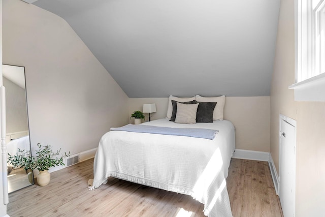 823 Owens St N, Stillwater, MN 55082 - bedroom featuring vaulted ceiling and wood finished floors
