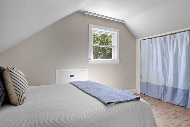 823 Owens St N, Stillwater, MN 55082 - bedroom featuring wood finished floors and vaulted ceiling