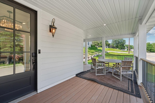 109 Pine St E, Stillwater, MN 55082 - wooden porch featuring outdoor dining space and view of golf course