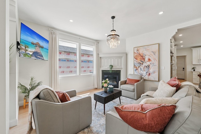 109 Pine St E, Stillwater, MN 55082 - living room featuring recessed lighting, a chandelier, light wood-style flooring, and a glass covered fireplace
