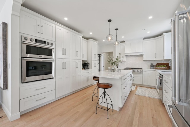 109 Pine St E, Stillwater, MN 55082 - kitchen featuring stainless steel appliances, a kitchen island, white cabinetry, and recessed lighting