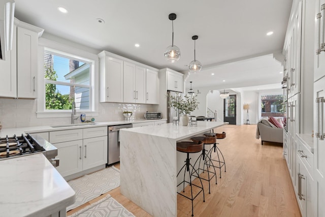 109 Pine St E, Stillwater, MN 55082 - kitchen featuring light wood finished floors, plenty of natural light, open floor plan, recessed lighting, and a center island