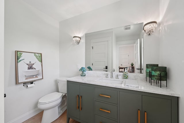 109 Pine St E, Stillwater, MN 55082 - bathroom featuring vanity, wood finished floors, and a chandelier