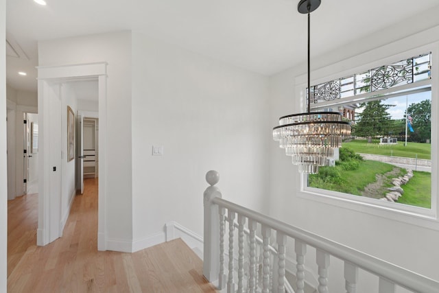109 Pine St E, Stillwater, MN 55082 - corridor featuring an upstairs landing, light wood-style flooring, a chandelier, and recessed lighting