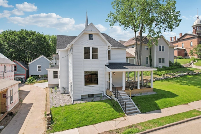 109 Pine St E, Stillwater, MN 55082 - victorian-style house with a shingled roof, covered porch, a front lawn, and a residential view