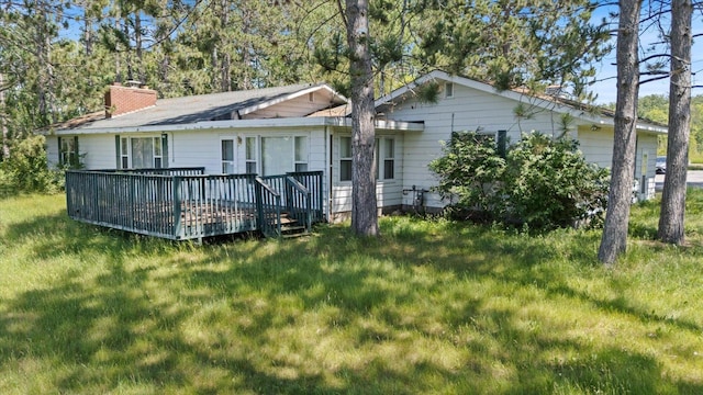 21837 Mishawaka Rd, Grand Rapids, MN 55744 - back of house featuring a deck, a chimney, and a lawn