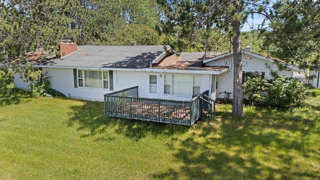 21837 Mishawaka Rd, Grand Rapids, MN 55744 - rear view of house featuring a yard, a wooden deck, and a chimney