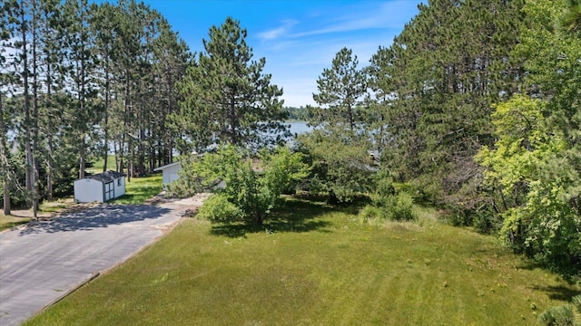 21837 Mishawaka Rd, Grand Rapids, MN 55744 - view of front of property with a storage shed, asphalt driveway, and a front yard
