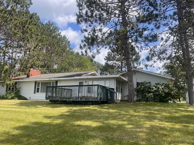 21837 Mishawaka Rd, Grand Rapids, MN 55744 - back of house with a lawn, a wooden deck, and a chimney